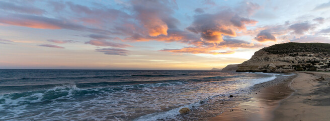 Sticker - beautiful panorama ocean sunset on the Costa del Sol in Spain with beach and cliffs in the background