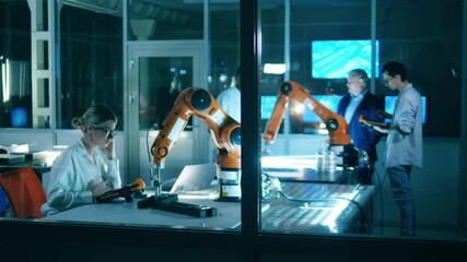 Wall Mural - robotics laboratory with a group of scientists having a discussion