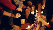 © CleverStock - Diverse group of young men and women sit around bonfire at dusk in forest drink tea and laugh vacation in nature happy picnic party in nature concept shot on red epic w