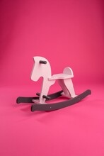 Close-up Of Rocking Horse Against Pink Background