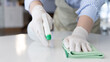 © Puwasit Inyavileart - Close up Staff hand Restaurant workers are cleaning table and spraying disinfectants during the virus outbreak, Using cleaning solutions or using alcohol to kill germs in the restaurant.