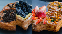 Danish Pastry Set Blueberry, Strawberry ,chocolate And Caramel Macadamia Serve On The Black Table In A Cafe Or Coffee Shop. Use For Breakfast Bakery Menu