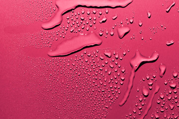 Wall Mural - Water drops on pink background, macro