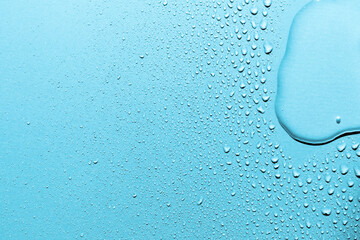 Wall Mural - Water drops on blue background, macro