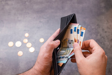 Close up of a man hands holding wallet with money banknotes