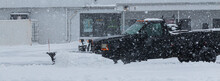 Private Contractor Plowing Parking Lot During A Blizzard