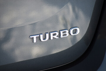 closeup of turbo sign on grey car