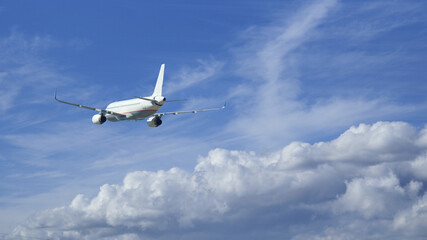 Zoom photo of passenger airplane taking off in deep blue cloudy sky