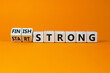 Start and finish strong symbol. Turned wooden cubes, changed words 'start strong' to 'finish strong'. Beautiful orange background, copy space. Business and start and finish strong concept.