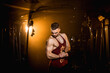 © Александр Шуневич - Muscular man shows biceps in the gym.