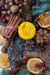 Wall Mural - Winter altar for Yule sabbath. pagan holiday. Sun and moon symbol, wheel of the year, cinnamon, nuts, cones, dry orange slices. Witchcraft Ritual for Yuletide, Magical Winter Solstice. flat lay