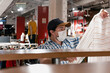 © juanpablo - man with a medical mask looking at clothes to buy