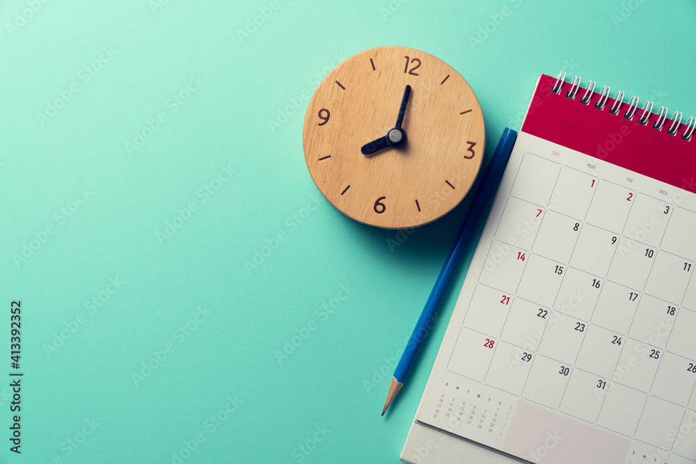 close up of calendar, pencil and alarm clock on the green table background, planning for business meeting or travel planning concept - obrazy, fototapety, plakaty 