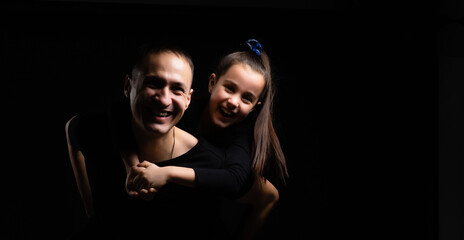 Wall Mural - father and daughter on black background