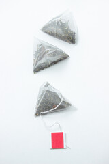 Wall Mural - Pyramid tea bags on a white background. Blank label for an inscription or logo. Instant tea