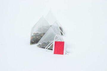 Wall Mural - Pyramid tea bags on a white background. Blank label for an inscription or logo. Instant tea