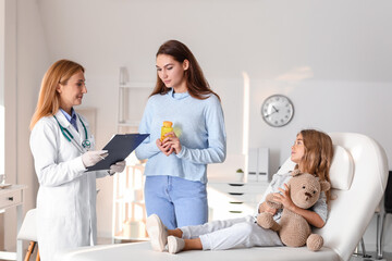 Sticker - Woman with her little daughter visiting pediatrician in clinic