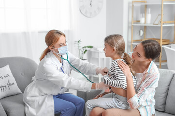 pediatrician examining little girl at home