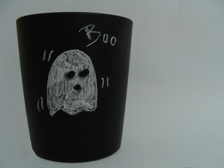 black chalkboard glass with a ghost drawn with white chalk on white background