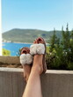 © FarukPhotography - Beautiful legs resting on sofa woman with background on sea landscape.