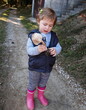 © FarukPhotography - Little girl in a cute dress holding aspen mushroom in her hand and smelling it. Picking edible mushrooms on the green lawn in the park.