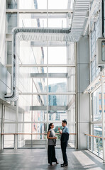 business people talking in modern office building. businessman and businesswoman standing and discus