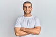 © Krakenimages.com - Young caucasian man wearing casual clothes and glasses happy face smiling with crossed arms looking at the camera. positive person.