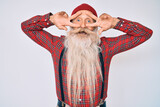 Fototapeta Tulipany - Old senior man with grey hair and long beard wearing hipster look with wool cap doing peace symbol with fingers over face, smiling cheerful showing victory