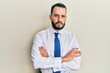 © Krakenimages.com - Young man with beard wearing business tie skeptic and nervous, disapproving expression on face with crossed arms. negative person.