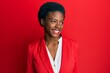 © Krakenimages.com - Young african american girl wearing business clothes looking away to side with smile on face, natural expression. laughing confident.