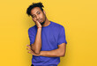 © Krakenimages.com - Young african american man with beard wearing casual purple t shirt thinking looking tired and bored with depression problems with crossed arms.