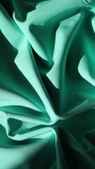 Wall Mural - beautifully crumpled dense fabric with the texture of folds creating the image of a flower, the mint color of the material shines in sunlight and goes into deep shadows in places of fold