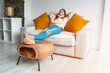 © Creative Cat Studio - Calm satisfied and relaxed woman in cozy sweater resting or sleeping on the sofa in the living room. Enjoying break with eyes closed, peace of mind, no stress. Day off work