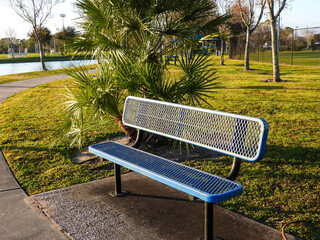 blue metal bench in park