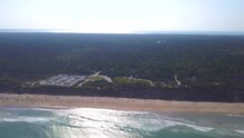 Bird's Eye View Of Nauset Beach And Lighthouse By Blue Sea With Sparkling Water In Eastham, Massachusetts. - Aerial