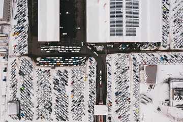 Wall Mural - Aerial view of the trucks unloading at the logistic center. Drone photography.