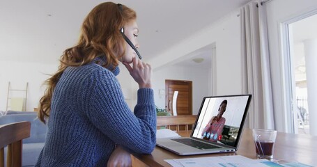 Poster - Caucasian woman using laptop and phone headset on video call with male colleague