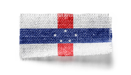 Netherlands Antilles flag on a piece of cloth on a white background