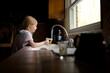 © Cavan Images - Girl filling cup with water in kitchen
