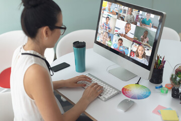 Sticker - Female teacher having a video conference with multiple students on computer at home