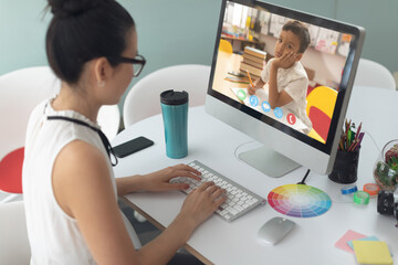 Poster - Female teacher having a video call with male student on computer at school