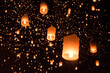 © Cavan Images - Low angle view of illuminated lanterns against sky at night