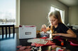 © Cavan Images - Girl preparing artwork while sitting at table