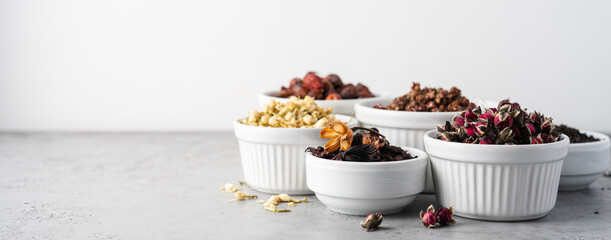 Different types of tea in bowl on white background. Rose hips, jasmine, rose flower, green, berry, hibiscus tea