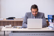 © Elnur - Young male employee unhappy with excessive work in the office