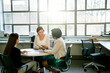 © Cavan Images - Businesswomen discussing at table in office