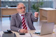 © Elnur - Aged businessman employee working in the office
