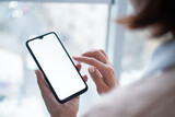 Fototapeta  - Woman holding phone with blank screen