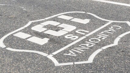 Pacific ocean Coast Highway road marking on asphalt, historic route 101, California State Route 1 roadtrip. Iconic emblem sign on freeway with dividing line in Oceanside, USA. Scenic road trip signage