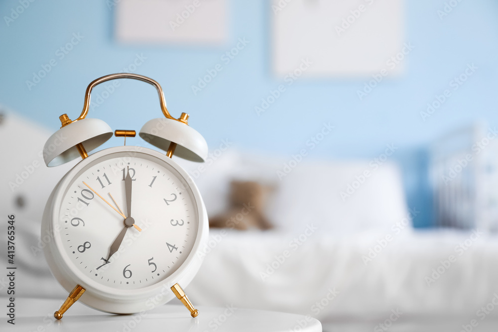 Alarm clock on table in bedroom